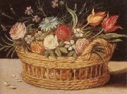 Still life of roses,tulips,chyrsanthemums and cornflowers,in a wicker basket,upon a ledge